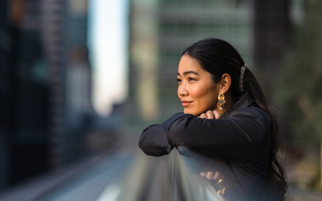 woman sitting, woman in black, city